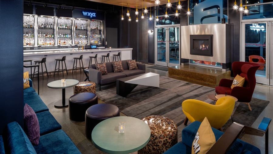 W XYZ bar lounge with fireplace and colourful seating