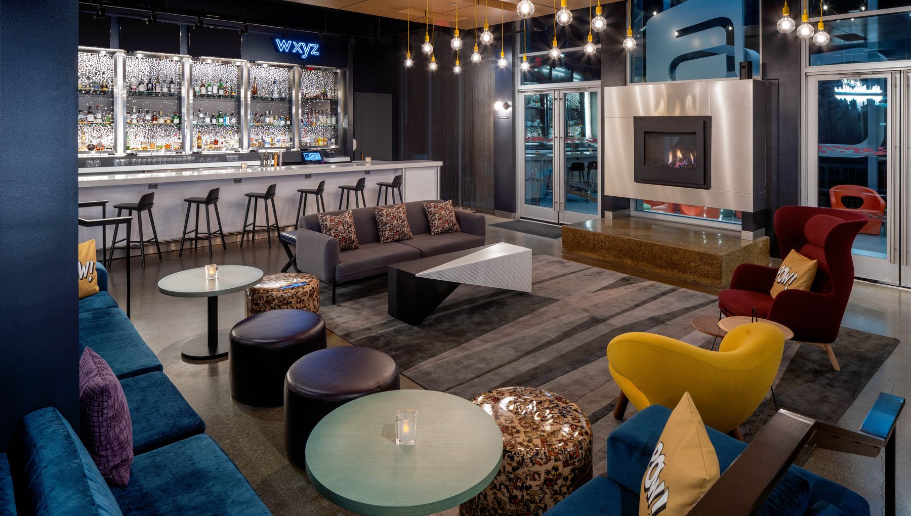 W XYZ bar lounge with fireplace and colourful seating