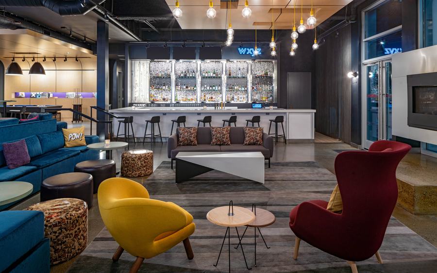 W XYZ bar with bold accent chairs and pendant lighting