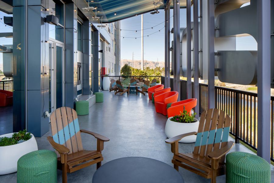 Outdoor porch with Adirondack chairs and city views