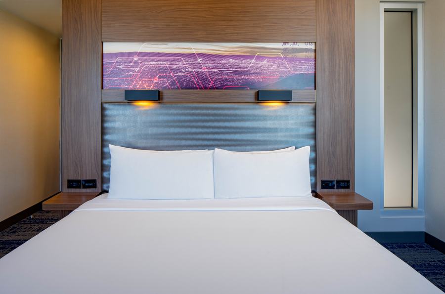 King guest room with backlit headboard art