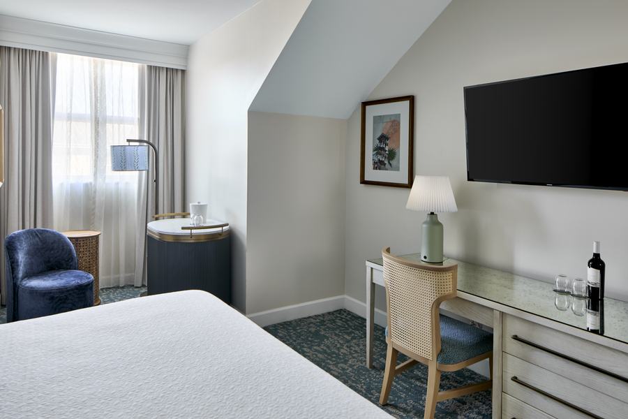 King guest room with desk and lounge chair