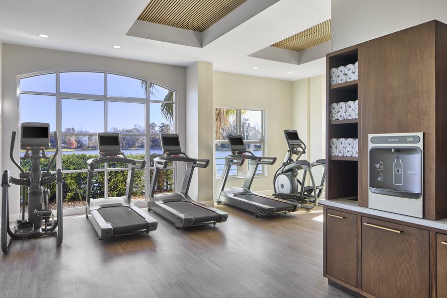 Fitness center with arched windows and water views