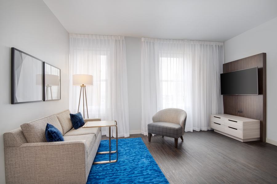 King suite living area with sofa and blue rug