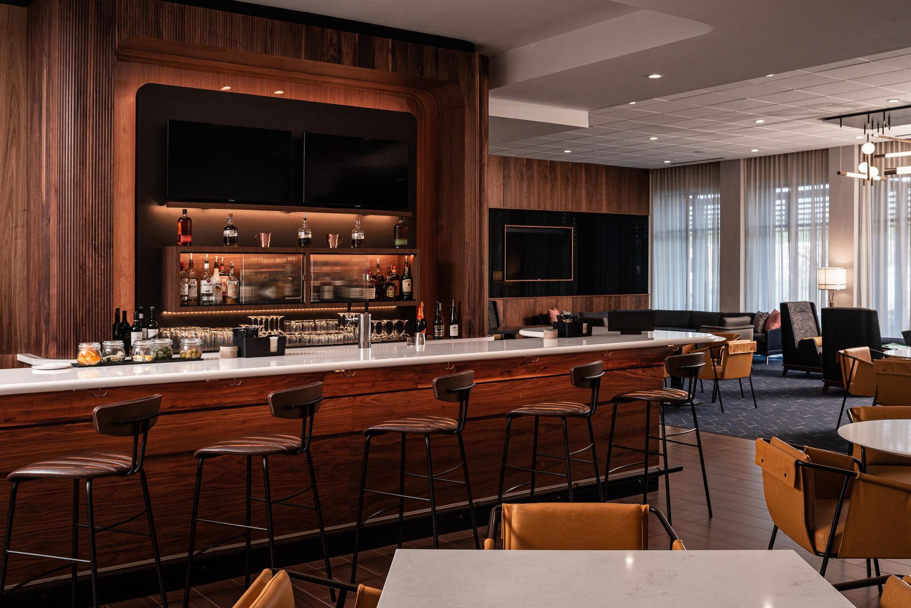 Bar with wood-panelled back bar and stools