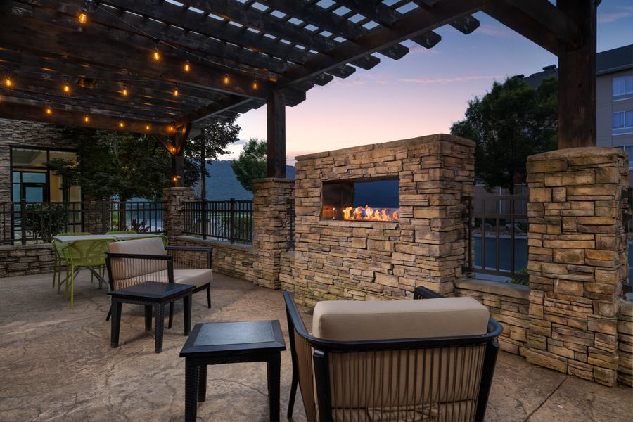 Outdoor patio with fireplace and pergola lighting