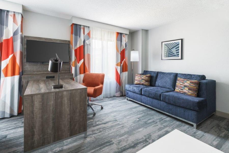 Guest room lounge area with blue sofa