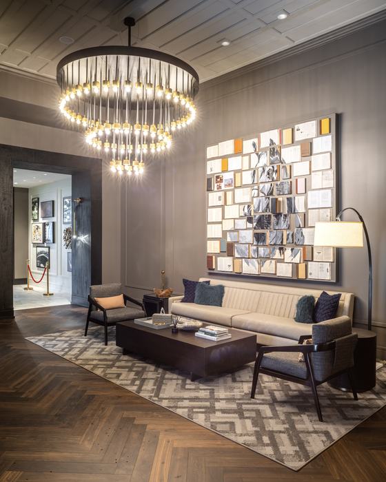 Lounge with tiered chandelier and gallery wall