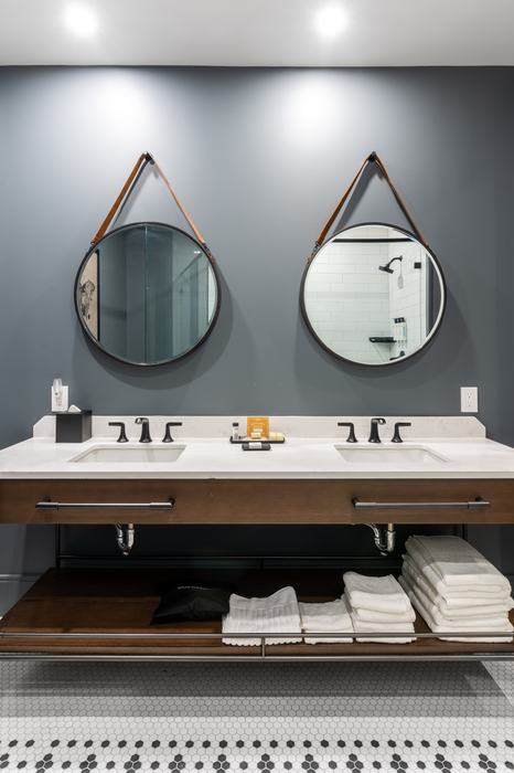 Double vanity with round strap mirrors